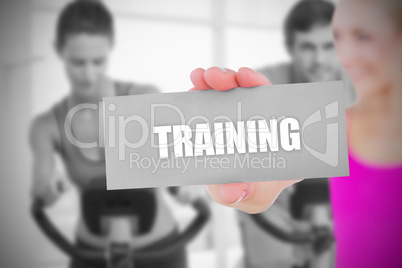 Fit blonde holding card saying training