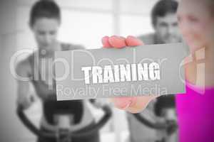 Fit blonde holding card saying training