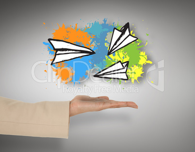 Composite image of female hand presenting paper airplanes