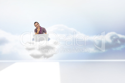 Composite image of thinking man sitting on cloud using laptop an