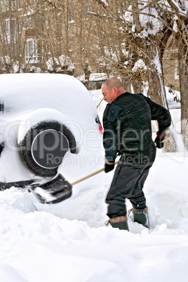 Man with a shovel in snow