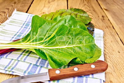 Mangold with knife and napkin on board