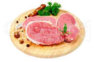 Meat pork slices with spices on round board