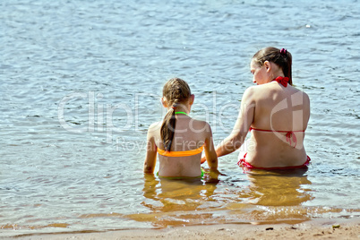 Mother and daughter in the water