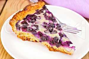 Pie blueberry in plate and napkin on board