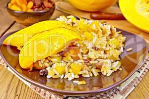 Pilaf fruit with pumpkin in brown plate on board