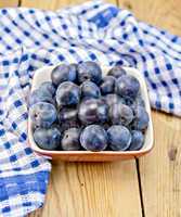 Plum blue in bowl on board with napkin