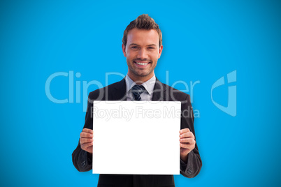 Composite image of businessman showing card