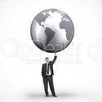 Composite image of businessman holding globe