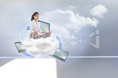 Composite image of businesswoman sitting in lotus pose