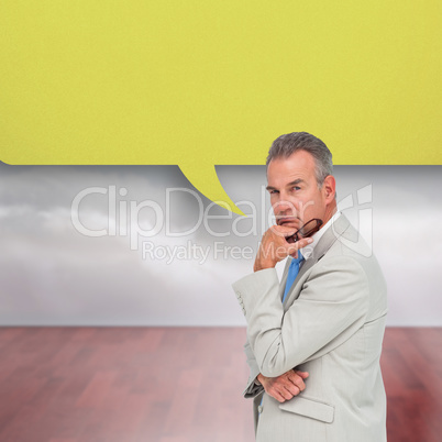 Composite image of thinking businessman with speech bubble