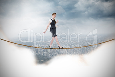 Composite image of businesswoman doing a balancing act