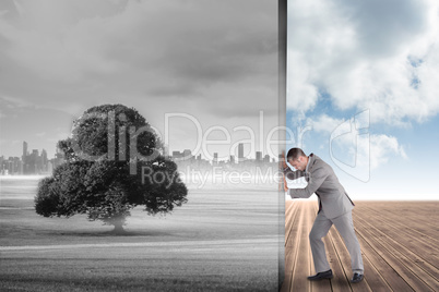 Composite image of businessman pushing away scene