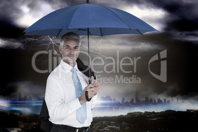 Composite image of businessman holding blue umbrella
