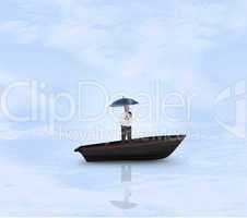 Composite image of happy businessman holding umbrella in a sailb