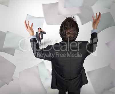 Composite image of gesturing businessman with tiny businessman