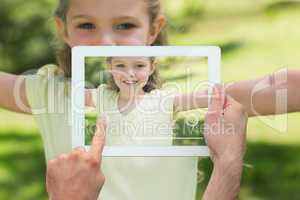 Composite image of hand holding tablet pc