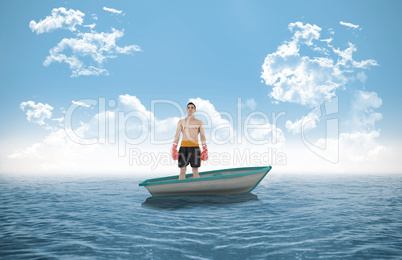 Composite image of boxer standing in a sailboat