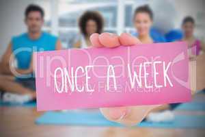 Woman holding pink card saying once a week