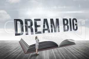 Dream big against open book against sky