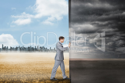 Composite image of businessman pushing away scene