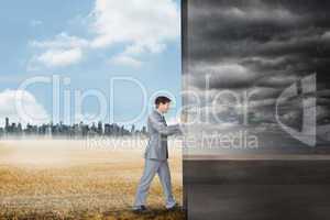 Composite image of businessman pushing away scene