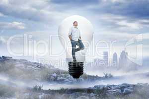 Composite image of thinking man in light bulb