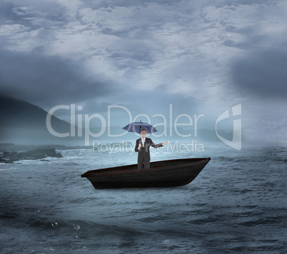 Composite image of peaceful businessman holding blue umbrella in