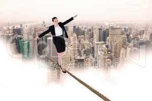 Composite image of businesswoman performing a balancing act