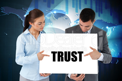 Business partners holding card saying trust
