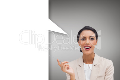 Composite image of smiling businesswoman holding a pen with spee