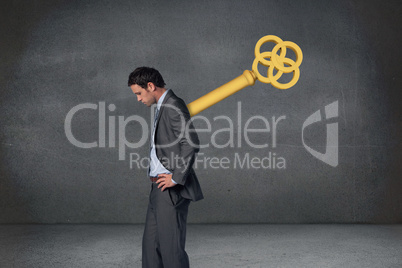 Composite image of wound up businessman with hands on hips