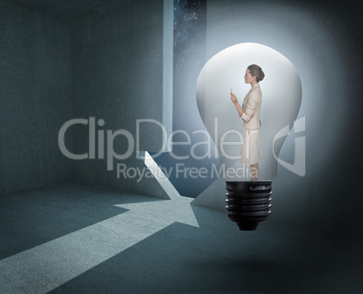 Composite image of thinking businesswoman in light bulb