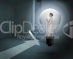 Composite image of thinking businesswoman in light bulb