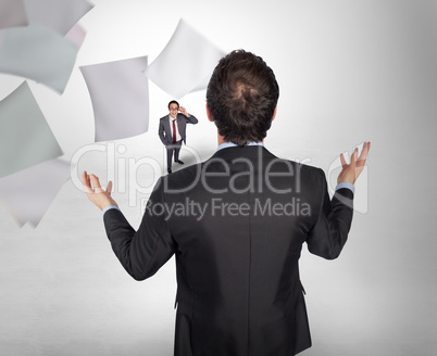 Composite image of gesturing businessman with tiny businessman