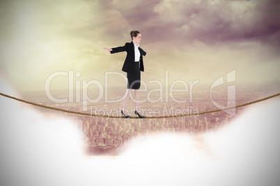 Composite image of businesswoman performing a balancing act