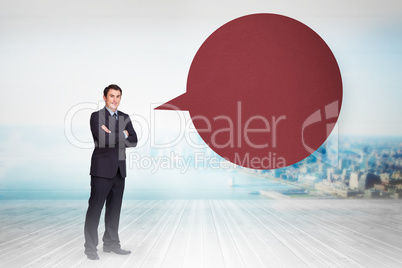 Composite image of young businessman standing cross-armed with s