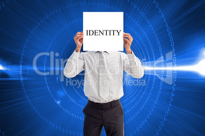 Businessman holding card saying identity
