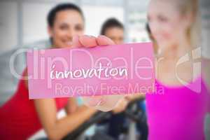 Fit blonde holding card saying innovation