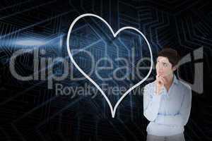 Composite image of heart and thinking businesswoman