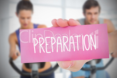 Woman holding pink card saying preperation