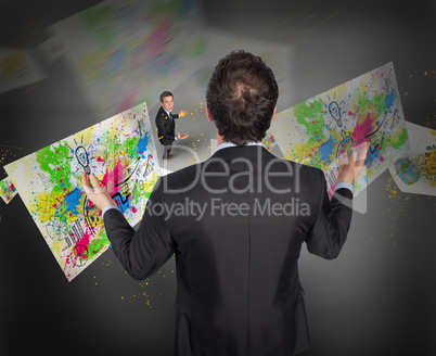 Composite image of gesturing businessman with tiny businessman