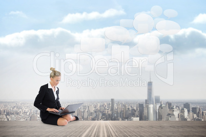 Composite image of businesswoman using laptop