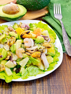 Salad seafood and avocado on dark board