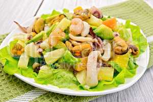 Salad seafood and avocado on light board