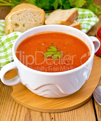 Soup tomato with pepper in bowl on board