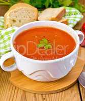 Soup tomato with pepper in bowl on board