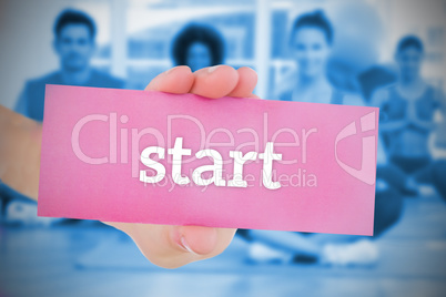 Woman holding pink card saying start