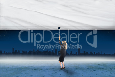 Composite image of businesswoman pulling a white screen