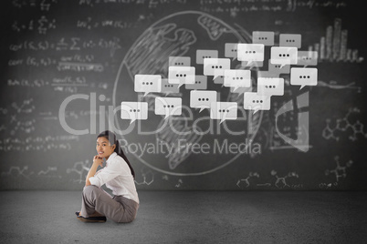 Composite image of businesswoman sitting cross legged with hands Composite image of businesswoman sitting cross legged with hands